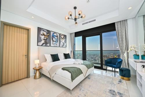 a bedroom with a bed and a large window at New Luxury SeaView 2Bed - Spectacular Rooftop Infinity Pool, Bar & Burj Views! in Dubai