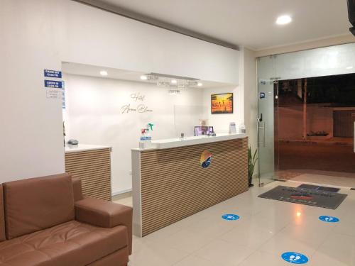 a waiting room with a couch and a counter at Hotel Arena Blanca in Salinas