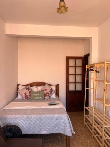 a bedroom with a bed with a pillow on it at Estalagem pé na areia in Arraial do Cabo