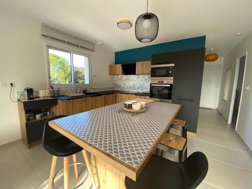 une cuisine avec une table et quelques chaises dans l'établissement Villa climatisée avec Wi-Fi et parking à Balaruc-les-Bains - FR-1-503-182, à Balaruc-les-Bains