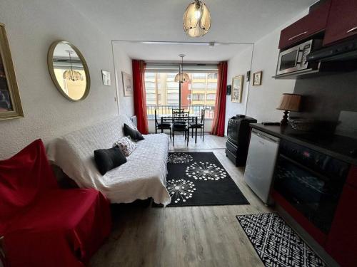 un salon avec un canapé rouge et une table dans l'établissement Studio à Argelès-sur-Mer avec Piscine et Parking privé - FR-1-388-229, à Argelès-sur-Mer