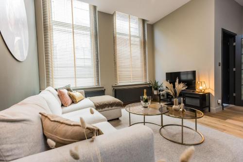 a living room with a couch and a table at Haya Historic - Rosé in The Hague