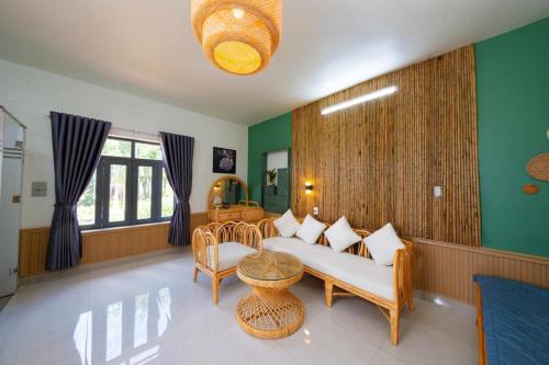 a living room with a couch and a table at Phú Điền Homestay in Tân Phú