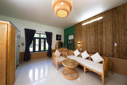 a living room with a couch and a table at Phú Điền Homestay in Tân Phú