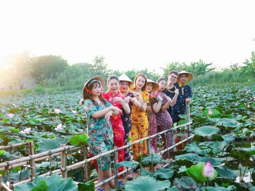 a group of children standing in a field of plants at Phú Điền Homestay in Tân Phú