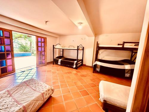 a bedroom with two bunk beds in a room at Paradise San Jeronimo Parcelacion 6BR AC Pool in San Jerónimo