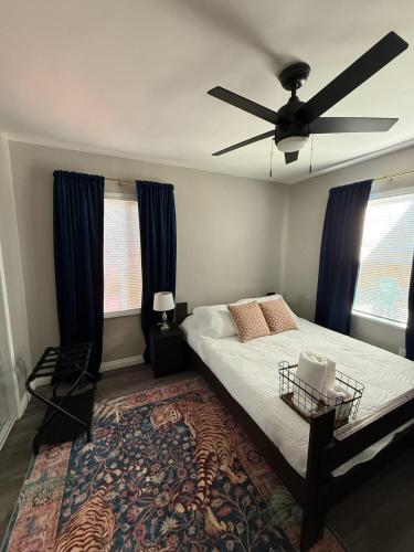 a bedroom with a bed and a ceiling fan at Bungalow in San Diego