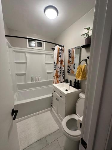a small bathroom with a toilet and a sink at Bungalow in San Diego