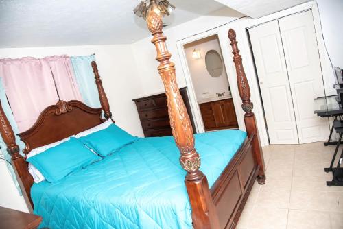 a bedroom with a four poster bed with blue sheets at COBE Enterprise in Danville