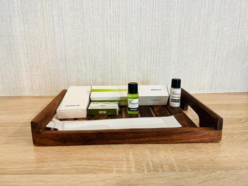 a wooden tray with some items on top of it at Harvey's Hotels - Gowlidoddy - Near US Consulate in Hyderabad