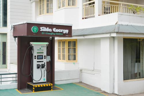 a shell energy gas pump in front of a building at Eastend Munnar in Munnar