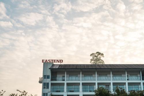 a building with a sign on top of it at Eastend Munnar in Munnar