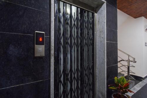 a black door with the number six on it at Super Collection O Gachibowli Phase - 1 Near ISB in Hyderabad