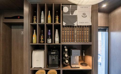 a cabinet filled with lots of bottles and appliances at Aank Ryokan Hotel Jeonju in Jeonju
