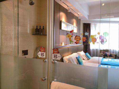a hotel room with a bed and a mirror at Kunming Haitian Hotel in Kunming