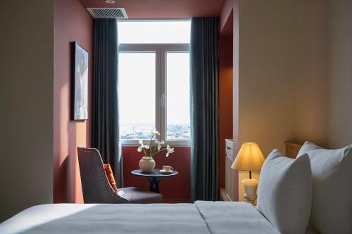 a hotel room with a bed and a window at M Village Hotel Long Biên in Hanoi