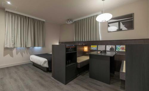 a bedroom with a bed and a desk with a sink at Aank Ryokan Hotel Jeonju in Jeonju