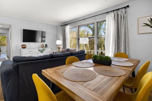 a dining room with a wooden table and yellow chairs at Cozy Home in Oak Ridge w 3BR in Oak Ridge