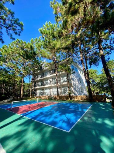 a tennis court in front of a building at Romeo & Juliet Dalat in Da Lat