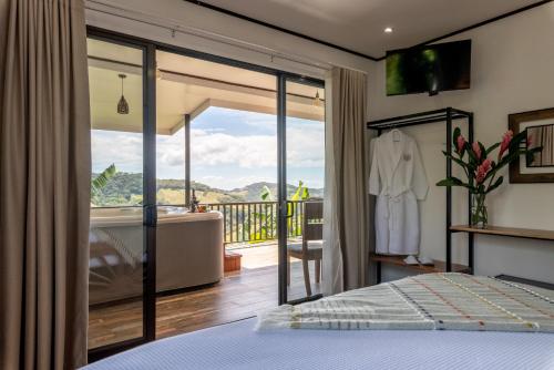 a bedroom with a bed and a balcony at Villa Alma de Campo Monteverde in Monteverde Costa Rica