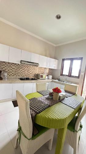 a kitchen with a table and chairs with a table and a tableablish at Kubu Dimel Suites Home in Nusa Dua