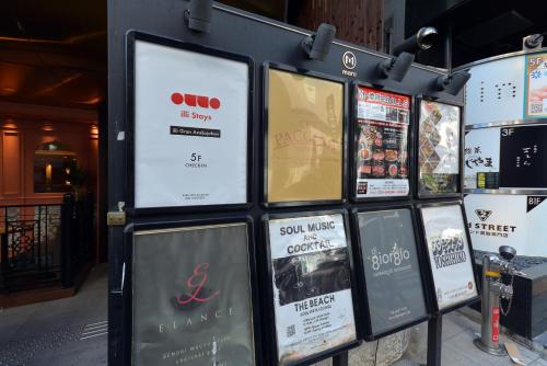 a bunch of signs on the side of a building at illi Gran Azabujuban in Tokyo