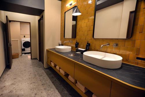 a bathroom with two sinks and a mirror at illi Gran Azabujuban in Tokyo