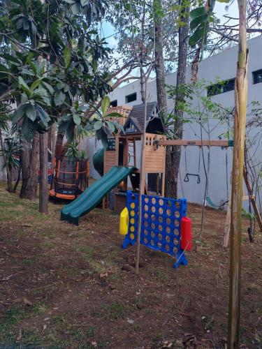 a playground with a slide and a tree house at Serenzzo Hotel & Cuisine in Tapalpa