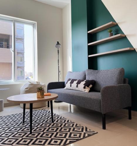 a living room with a couch and a table at LOKAL Flagship x Karachi - DHA in Karachi