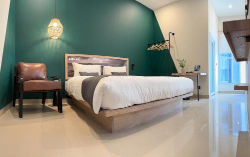 a bedroom with a bed and a green wall at LOKAL Flagship x Karachi - DHA in Karachi
