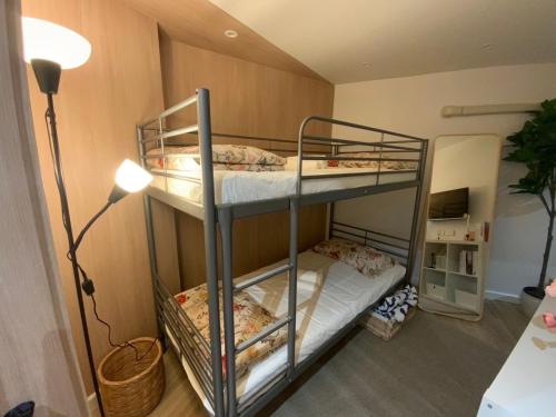 two bunk beds in a room with a lamp at 103 Family Home Nimman in Chiang Mai
