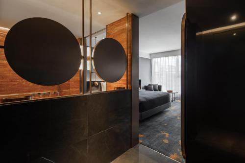 a bedroom with two mirrors on a wall at Wanda Yi, Xi'an The Linow in Xi'an