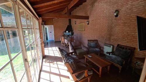 a living room with a couch and chairs and a table at La Quinta Rosefe in Luján