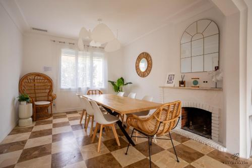 a dining room with a table and chairs and a fireplace at Zen Paradise - Near the city center - Garden in Perpignan