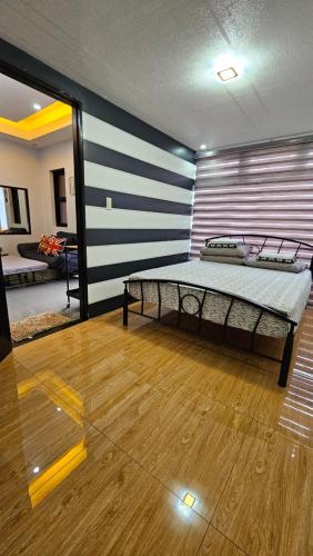 a bedroom with a bed in a room at Jolie Joes One Bedroom Unit in Tagudin
