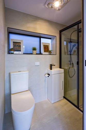 a bathroom with a toilet and a shower at Beautiful Bush & Yoga Retreat Guest Favourite 6 Stars in Engadine