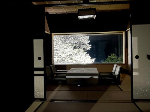 a room with a bed and a window at Ryuguden in Hakone