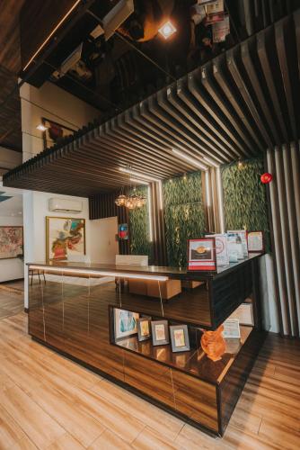 a display case in a room with paintings on the wall at SureStay Plus Hotel by Best Western AC LUXE Angeles City in Angeles