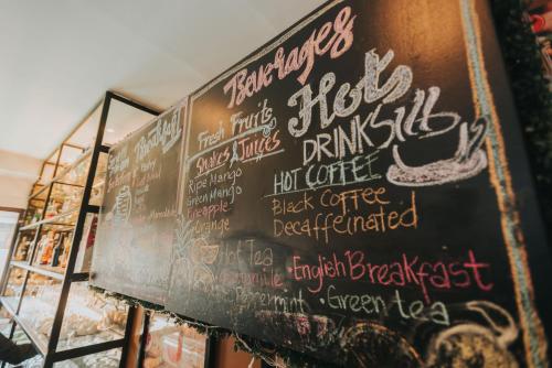 a chalkboard with writing on it in a restaurant at SureStay Plus Hotel by Best Western AC LUXE Angeles City in Angeles
