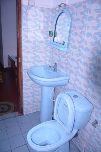 a bathroom with a toilet and a sink at Choice hotels in Haputale