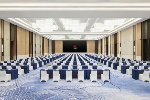 an empty conference room with chairs and a stage at Jieyang Marriott Hotel in Jieyang