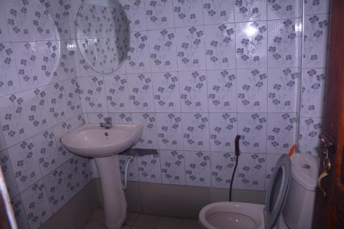 a bathroom with a sink and a toilet at Choice hotels in Haputale