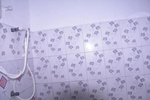 a bathroom with a shower with flowers on the wall at Choice hotels in Haputale