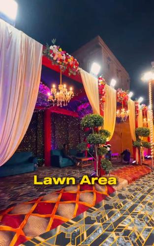 a set up for a party with curtains and flowers at The Blessing Palace in Muzaffarpur
