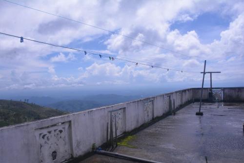 a view from the top of a mountain with birds on a wire at Choice hotels in Haputale