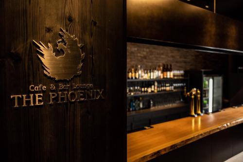 a bar with a sign that says cafe and bar junior the phoenix at Wyndham Garden Sapporo Odori in Sapporo