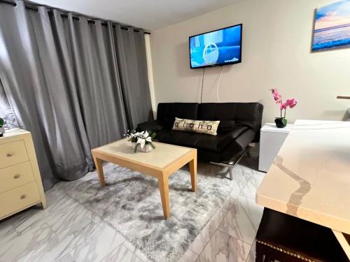 a living room with a couch and a coffee table at Aqua Aloha Surf Waikiki Hotel, 5 minute walk to the beach in Honolulu