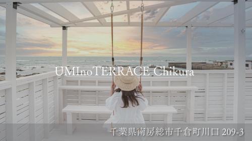 a little girl sitting on a bench looking at the ocean at UMInoTERRACE in Minamiboso