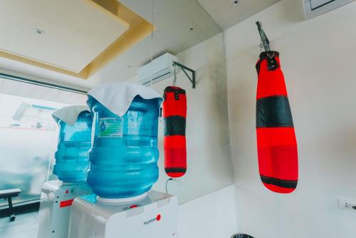 two red and blue punching bags hanging on a wall at SureStay Studio by Best Western Clarkview Angeles City in Angeles