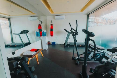 a gym with two exercise bikes in a room at SureStay Studio by Best Western Clarkview Angeles City in Angeles